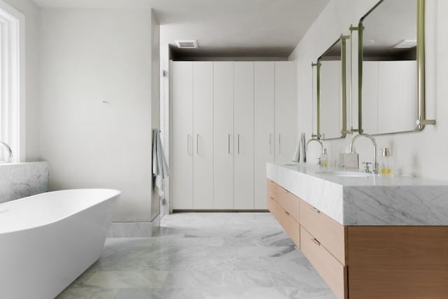 4101 Mcbrine Pl, Austin, TX 78746 - full bath with double vanity, a freestanding bath, and marble finish flooring
