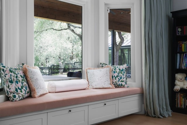 living area featuring plenty of natural light and light hardwood / wood-style flooring