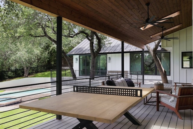 deck with a pool and ceiling fan