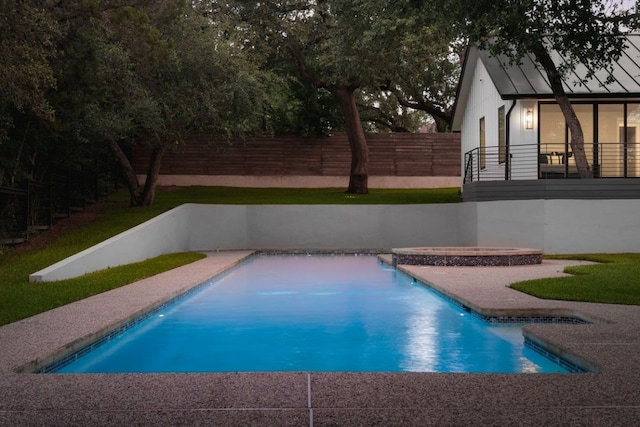 view of swimming pool with an in ground hot tub