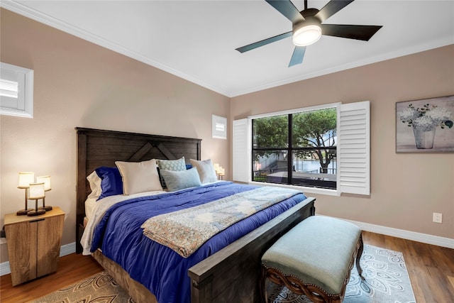 bedroom featuring ceiling fan, wood-type flooring, and ornamental molding