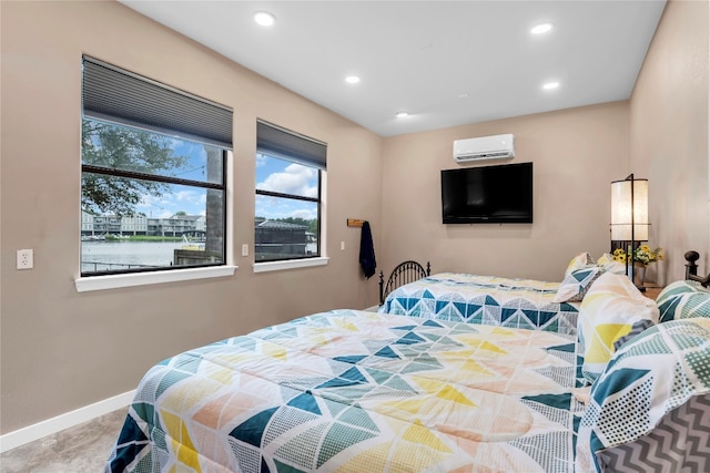 bedroom featuring an AC wall unit and a water view