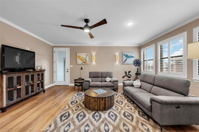 living room with crown molding, light hardwood / wood-style flooring, and ceiling fan