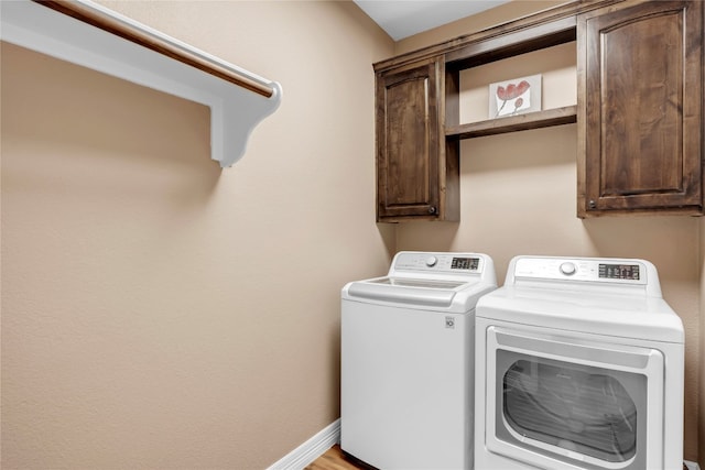 laundry room with cabinets and independent washer and dryer