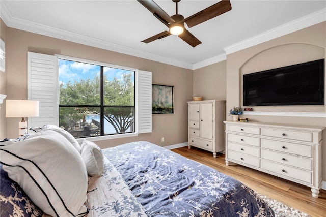 bedroom featuring light hardwood / wood-style flooring, ceiling fan, and ornamental molding