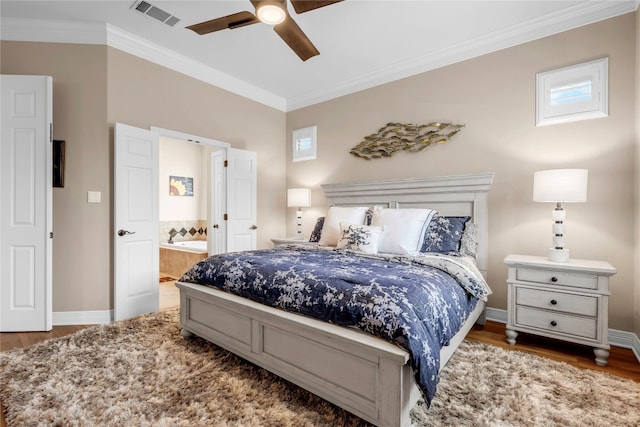 bedroom featuring connected bathroom, dark hardwood / wood-style floors, ceiling fan, and crown molding