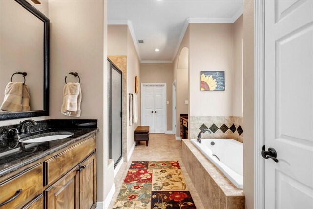 bathroom featuring shower with separate bathtub, vanity, tile patterned floors, and crown molding