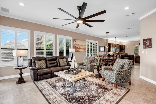 living room with light tile patterned floors, ceiling fan, and crown molding