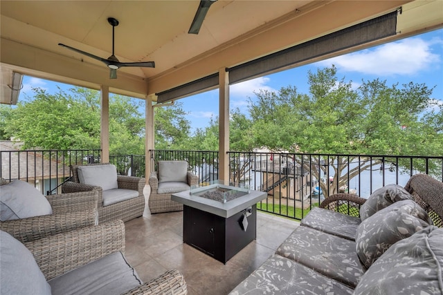 sunroom / solarium featuring ceiling fan, a water view, and lofted ceiling