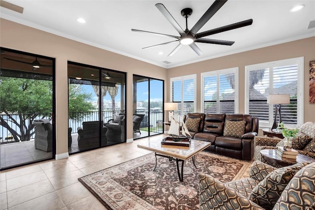 tiled living room with ceiling fan, ornamental molding, and a wealth of natural light