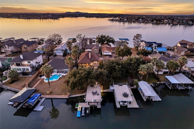 aerial view at dusk with a water view