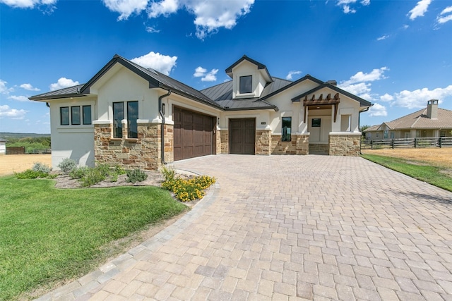 view of front of property with a front yard and a garage