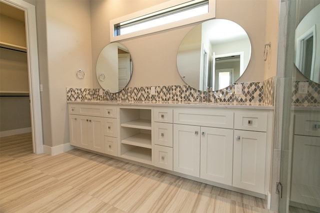 bathroom with wood-type flooring, vanity, tasteful backsplash, and a shower with shower door