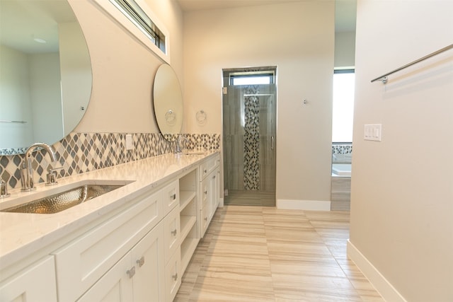 bathroom with backsplash, tile patterned floors, vanity, and shower with separate bathtub