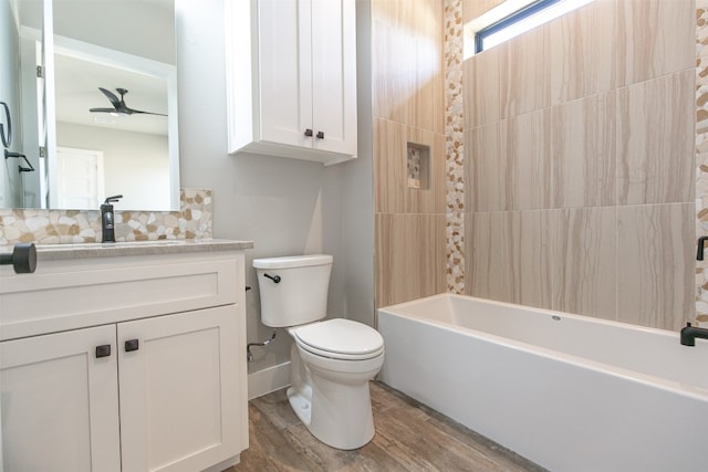 full bathroom featuring ceiling fan, backsplash, toilet, vanity, and hardwood / wood-style flooring