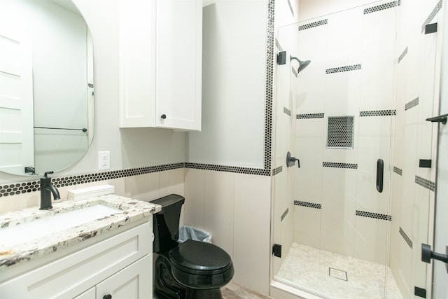 bathroom featuring vanity, toilet, and an enclosed shower