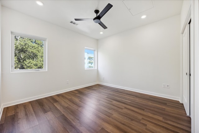 unfurnished bedroom with dark hardwood / wood-style flooring, multiple windows, and ceiling fan