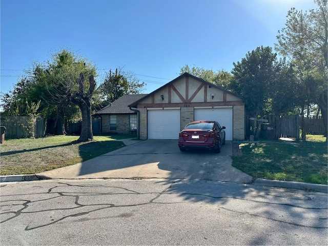 view of front of property featuring a garage and a front lawn