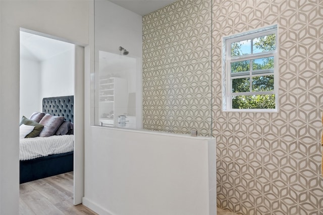 bathroom with a shower and hardwood / wood-style floors