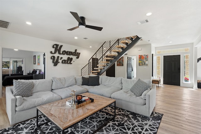 living room with ceiling fan and light hardwood / wood-style floors