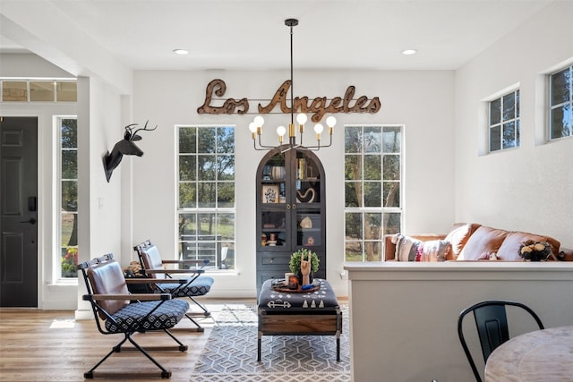 interior space with hardwood / wood-style floors and an inviting chandelier