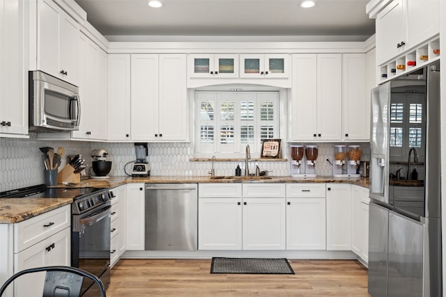 kitchen featuring white cabinetry, sink, and appliances with stainless steel finishes