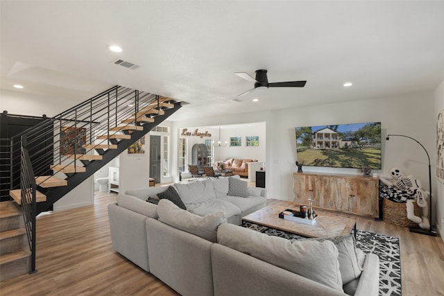 living room with ceiling fan and light wood-type flooring