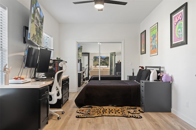 bedroom with light wood-type flooring, multiple windows, and ceiling fan