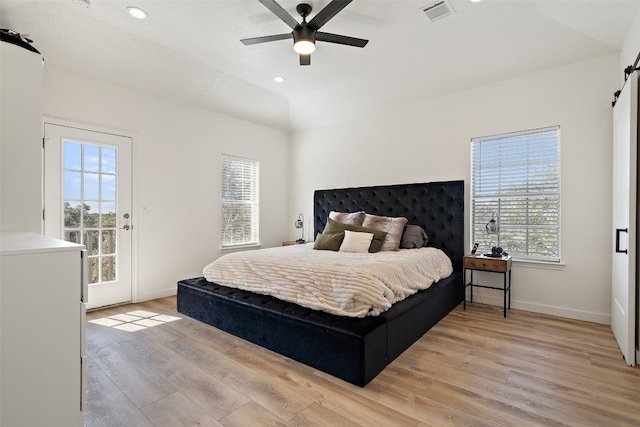 bedroom featuring multiple windows, ceiling fan, and light hardwood / wood-style floors