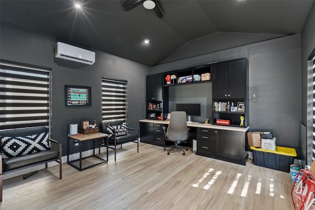 office area featuring lofted ceiling, ceiling fan, light hardwood / wood-style floors, and a wall mounted air conditioner