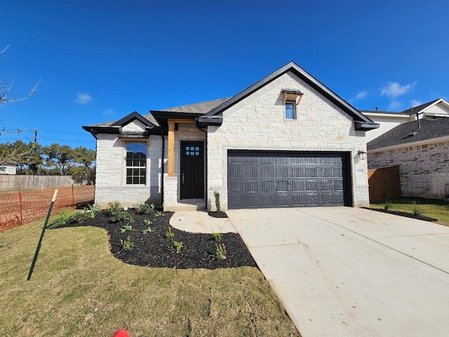 view of front of home featuring a garage and a front yard