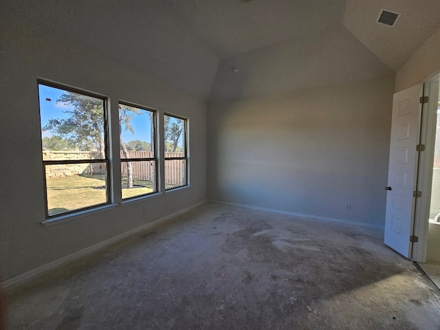 unfurnished room featuring lofted ceiling