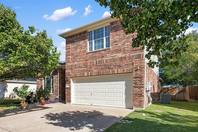 front of property featuring cooling unit, a front yard, and a garage