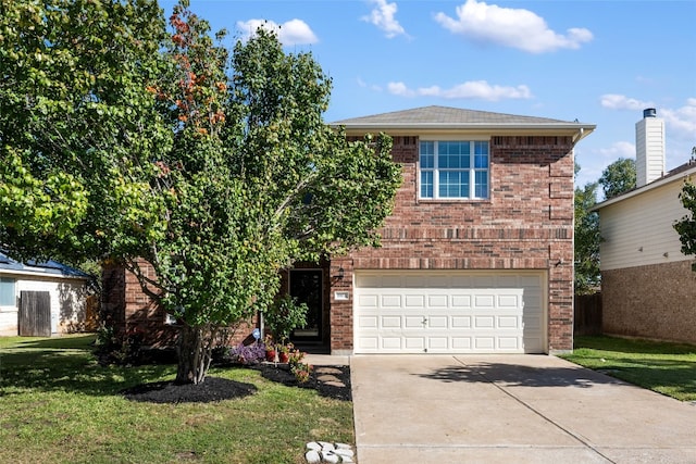 view of front of home featuring a garage and a front yard