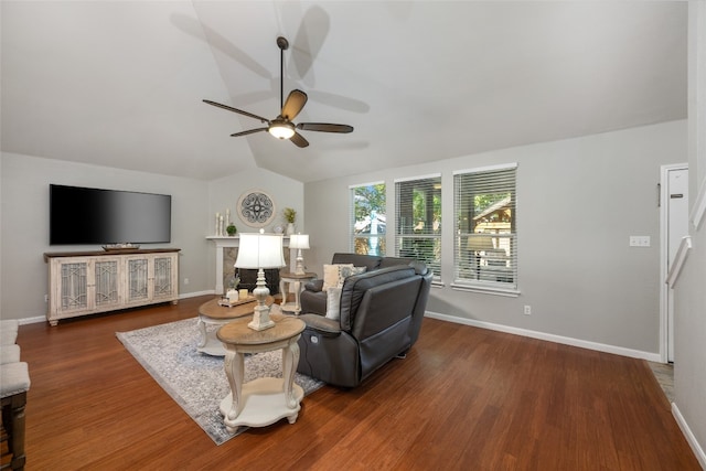 living room with dark hardwood / wood-style flooring, ceiling fan, and lofted ceiling