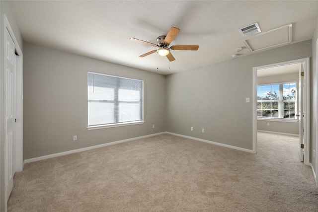 carpeted empty room featuring ceiling fan