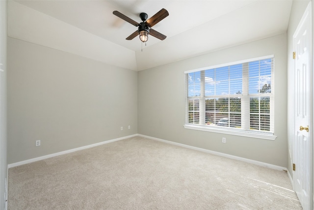 carpeted spare room featuring ceiling fan