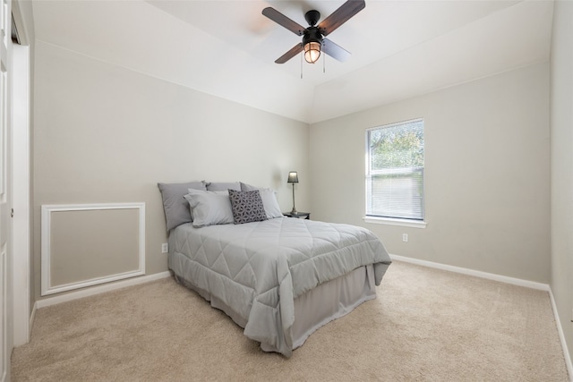 carpeted bedroom with ceiling fan and lofted ceiling