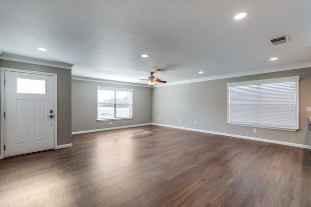 foyer featuring dark hardwood / wood-style floors, ceiling fan, ornamental molding, and a textured ceiling