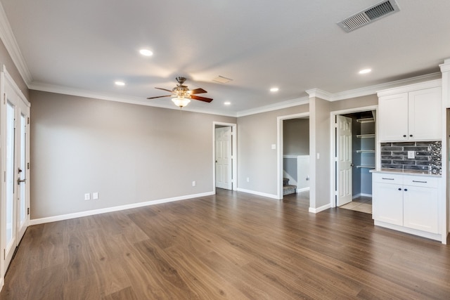 unfurnished living room featuring ceiling fan, dark hardwood / wood-style flooring, and ornamental molding