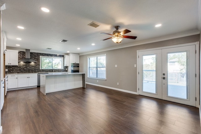 kitchen featuring white cabinets, french doors, dark hardwood / wood-style floors, and wall chimney range hood