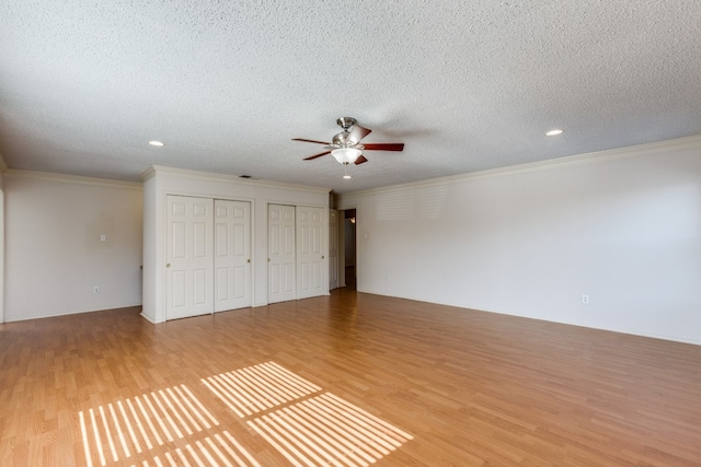 unfurnished bedroom with ceiling fan, crown molding, light hardwood / wood-style floors, and a textured ceiling