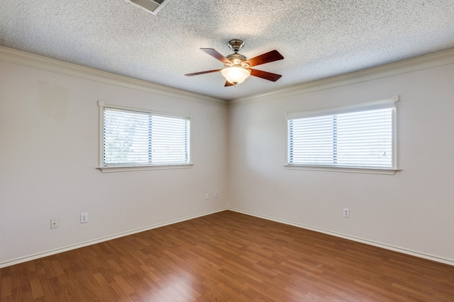 empty room with hardwood / wood-style flooring, ceiling fan, crown molding, and a textured ceiling