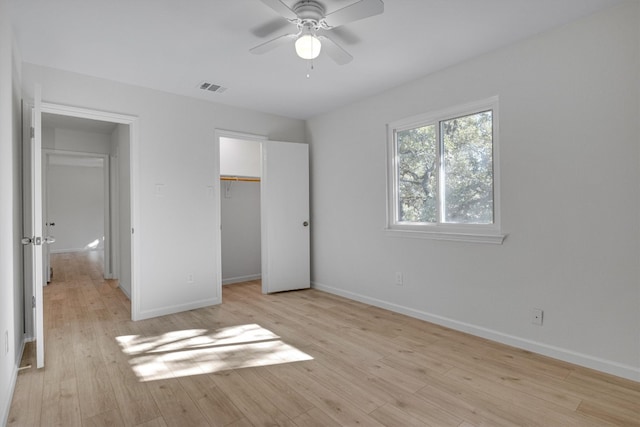 unfurnished bedroom featuring a closet, ceiling fan, and light wood-type flooring