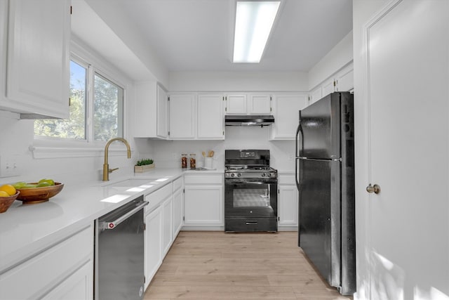 kitchen with sink, light hardwood / wood-style flooring, black appliances, and white cabinets