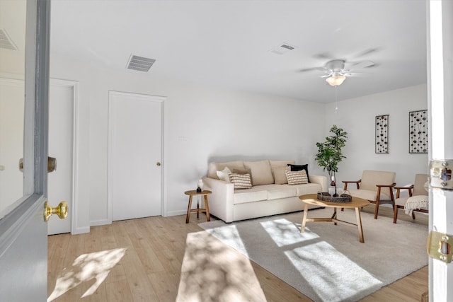 living room featuring ceiling fan and light wood-type flooring