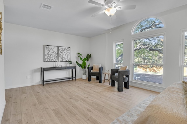 living area featuring ceiling fan and light wood-type flooring