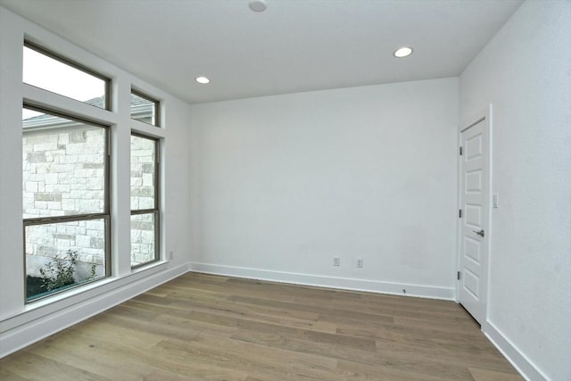 spare room with hardwood / wood-style flooring