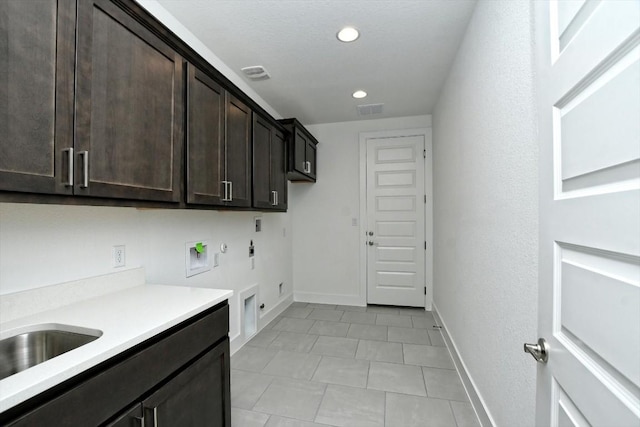 washroom featuring sink, gas dryer hookup, cabinets, washer hookup, and hookup for an electric dryer