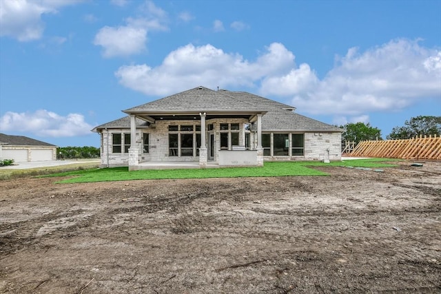 rear view of house featuring a yard and a patio